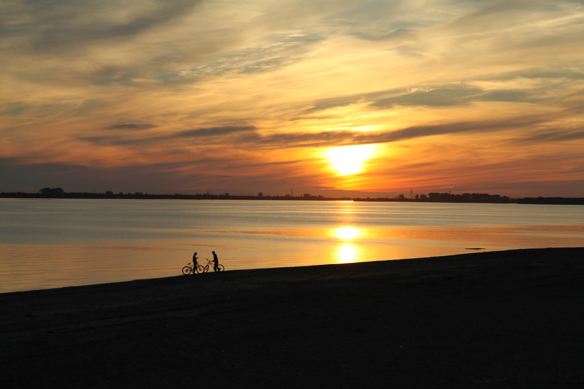 bicycles on Dvina beach at sunset