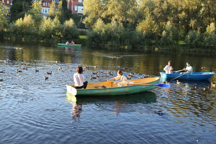 Pskov River girls in boat and ducks without boat